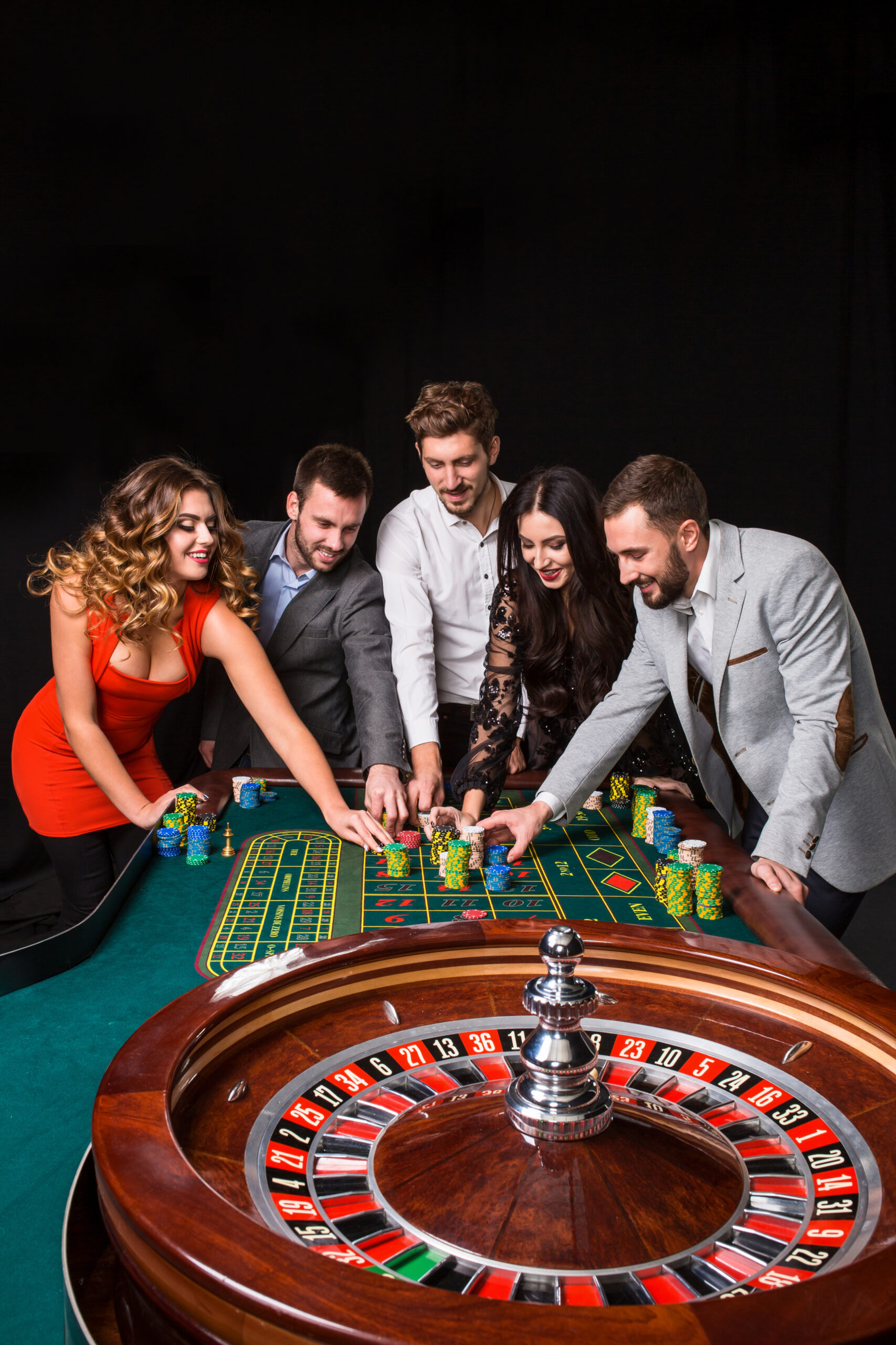 group of young people behind roulette table